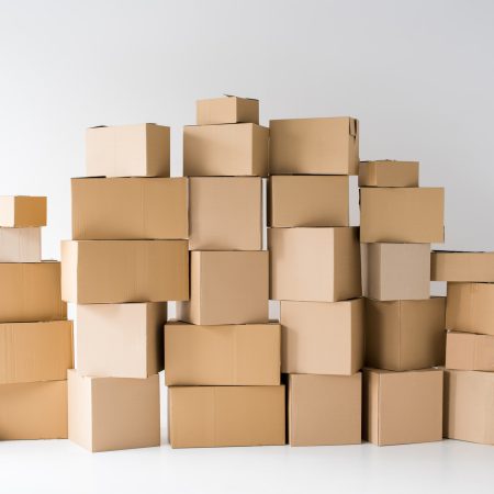 brown cardboard boxes stacked on each other on white